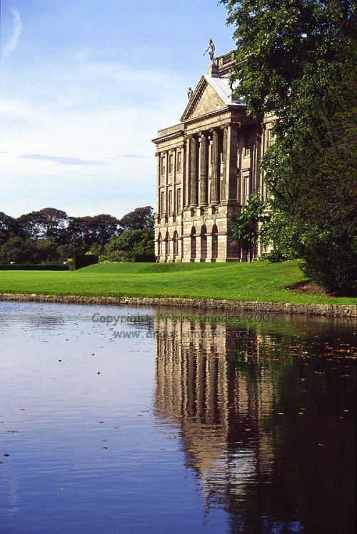 The Facade of Lyme Hall reflected in the lake