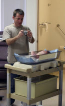 New Dad Stacey taking photos of Cora's first time on a scale.