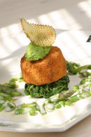 Fishcakes with green vegetables and butter sauce.