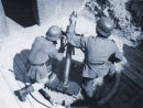 Troops firing a mortar.
