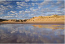 Golden dunes and cotton wool clouds
