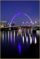 The Squinty Bridge and lights reflected in the River Clyde