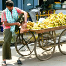 Banana vendor rubs his sore feet