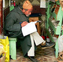 Souk stallholder doing his books