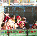 Women workers in back of a truck