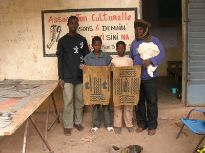 Oumar and Bassidy with two young students