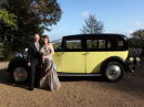 Happy Couple with Wedding Car.