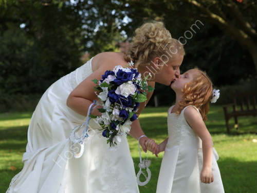 Tara kissing a young bridesmaid - from Tara & Paul's wedding at Bishopstoke.